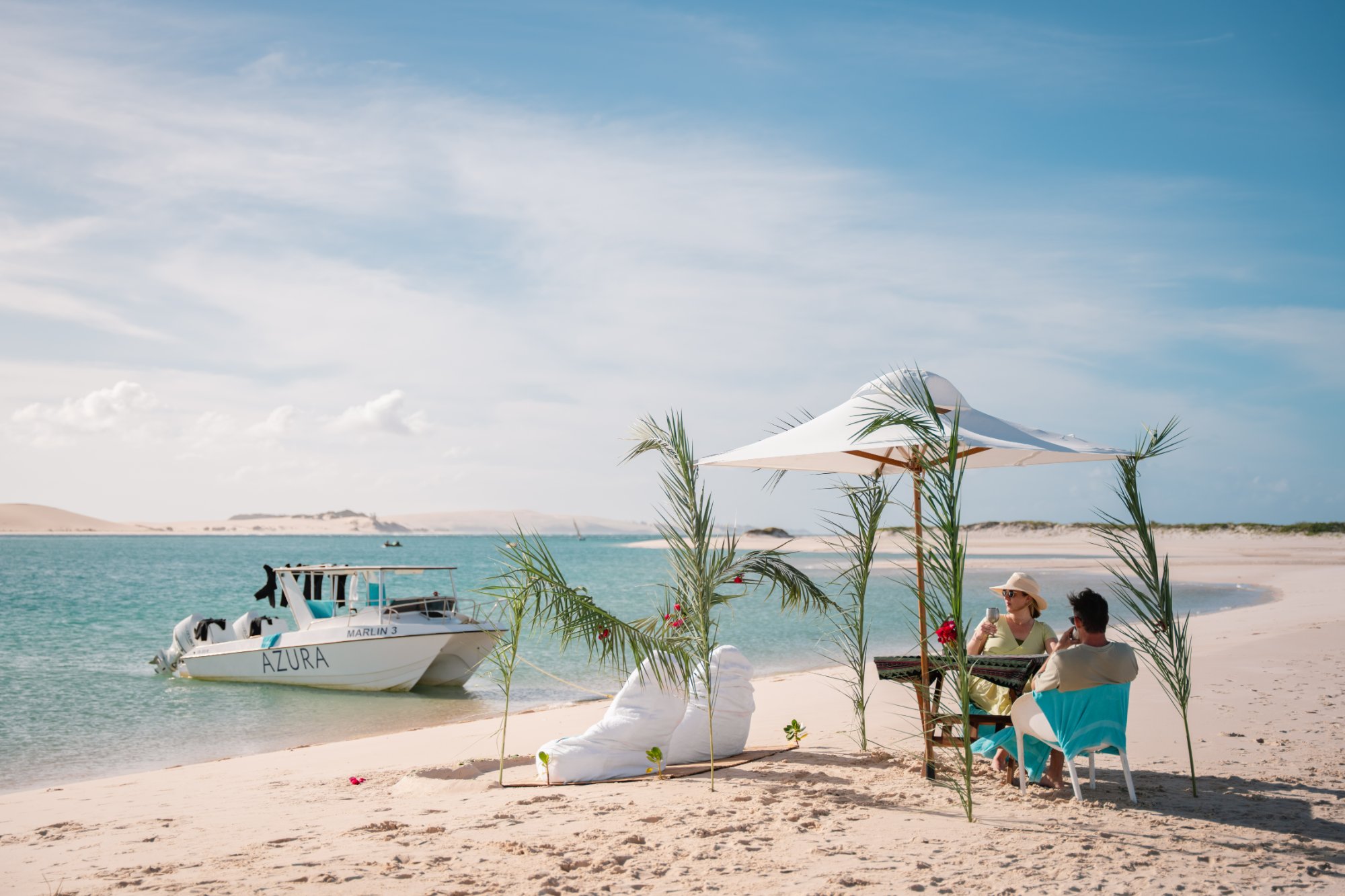 Couple enjoying a private beach picnic on Benguerra Island, Mozambique